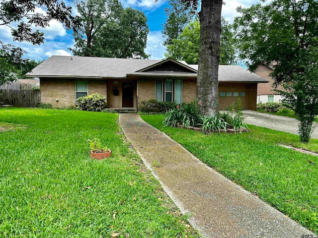 view of front facade with a garage and a front yard