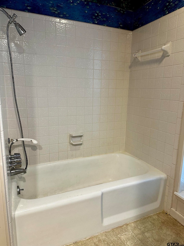 bathroom featuring tile patterned flooring and tiled shower / bath combo