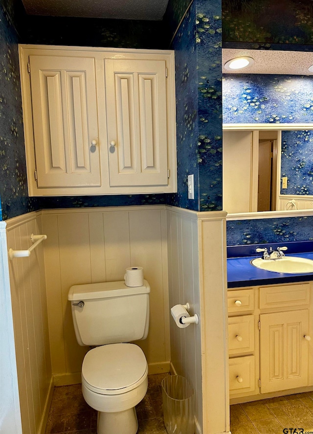 bathroom with tile patterned floors, vanity, and toilet