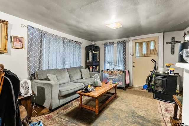 living room with a textured ceiling and a wood stove