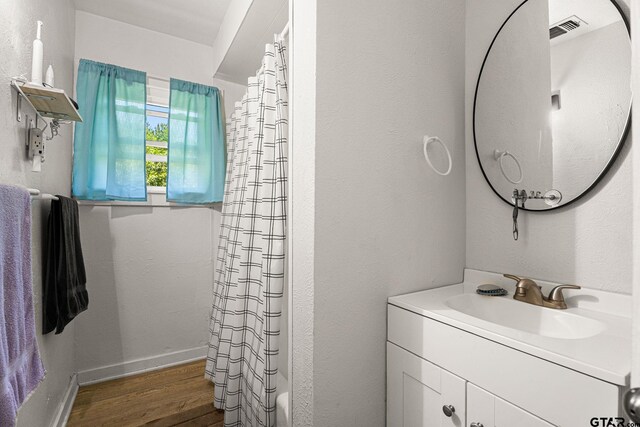 298 Butler St, Rusk, TX 75785 - full bath with wood finished floors, vanity, and baseboards