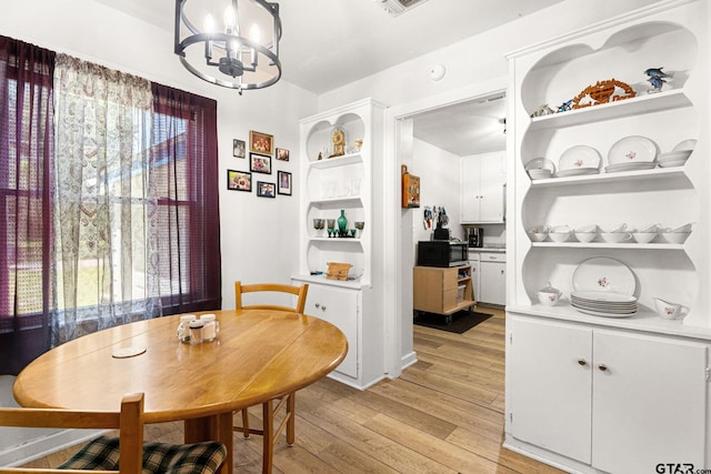 298 Butler St, Rusk, TX 75785 - dining space with light wood-type flooring and a chandelier