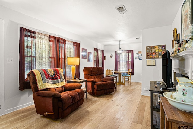 298 Butler St, Rusk, TX 75785 - living room with light wood-style floors, baseboards, and a fireplace