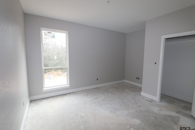 11905 Gillian Ct, Tyler, TX 75703 - unfurnished bedroom featuring baseboards and unfinished concrete flooring