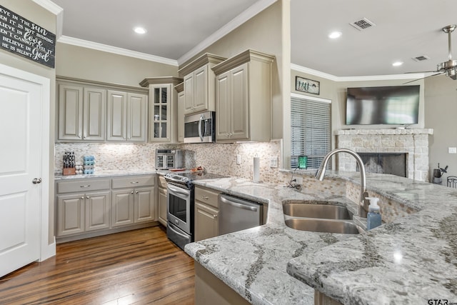 275 Babatwa Ln, Bullard, TX 75757 - kitchen with appliances with stainless steel finishes, crown molding, ceiling fan, light stone countertops, and dark wood-style floors