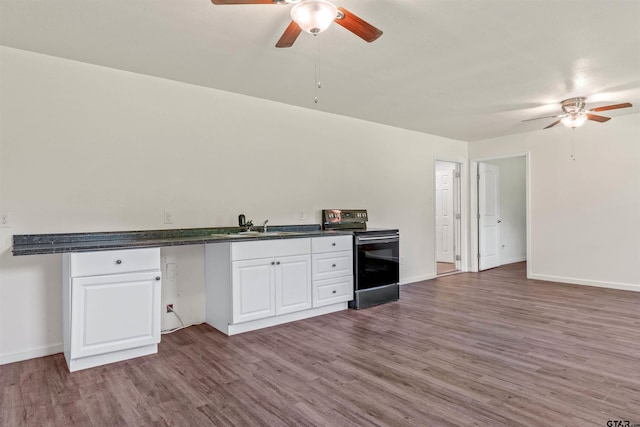 kitchen with white cabinets, black / electric stove, wood-type flooring, and ceiling fan