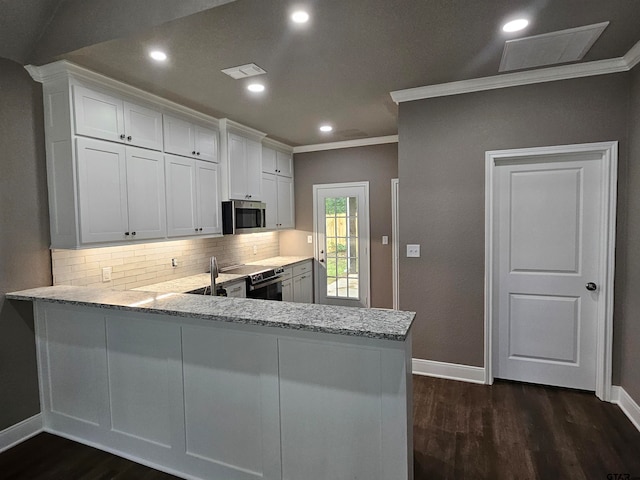 kitchen featuring white cabinets, crown molding, and kitchen peninsula