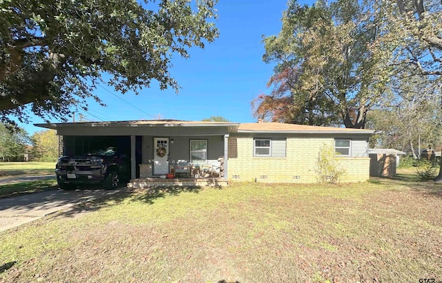 ranch-style home with a front lawn and a carport