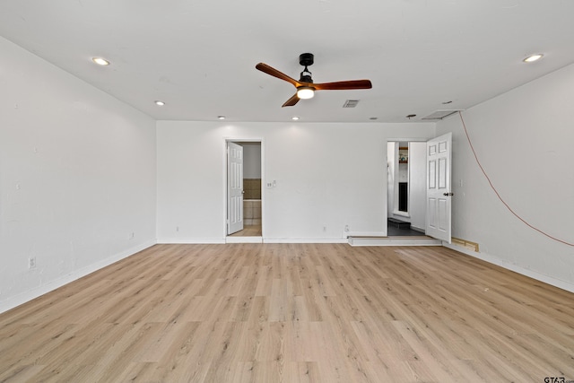 spare room featuring light hardwood / wood-style flooring and ceiling fan