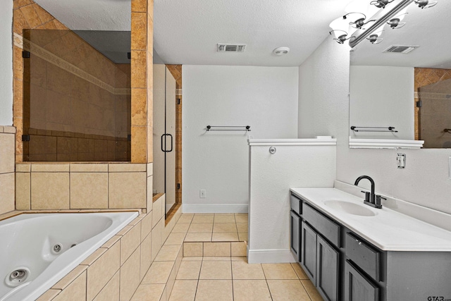 bathroom with tile patterned flooring, vanity, a textured ceiling, and independent shower and bath