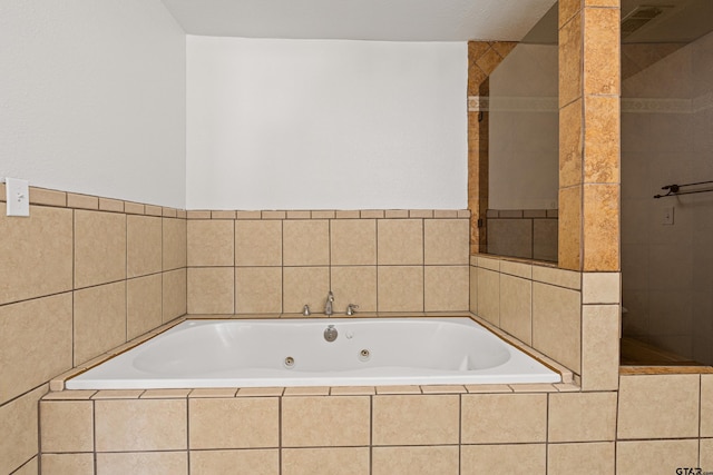 bathroom with a relaxing tiled tub