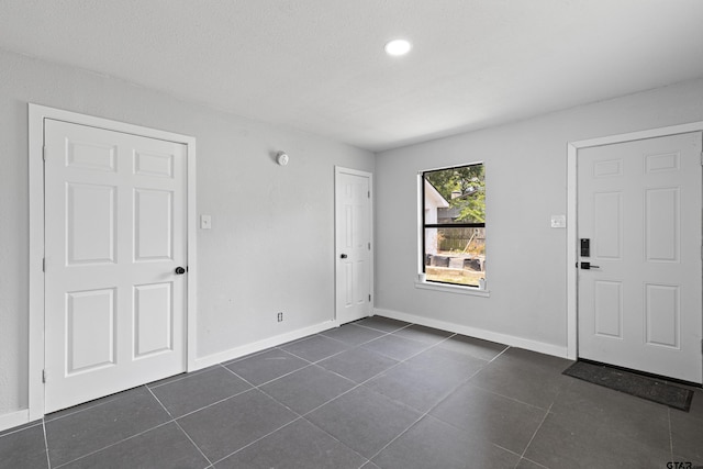 empty room featuring dark tile patterned flooring