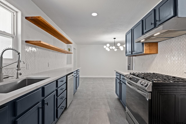 kitchen featuring an inviting chandelier, sink, tasteful backsplash, appliances with stainless steel finishes, and decorative light fixtures