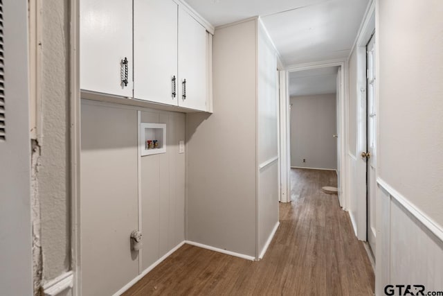 washroom featuring washer hookup, cabinets, and hardwood / wood-style floors