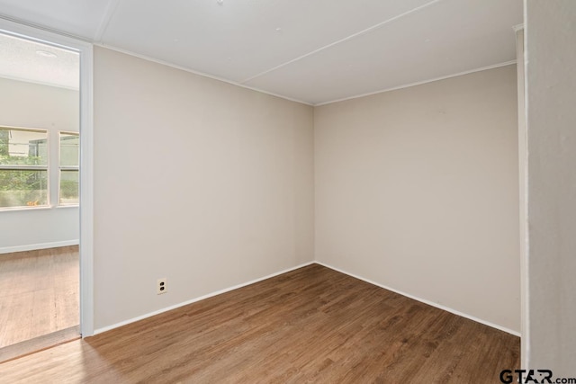 unfurnished room with hardwood / wood-style flooring