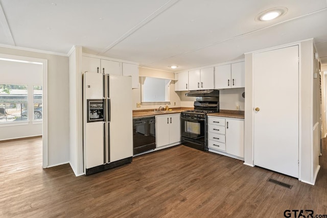 kitchen with crown molding, white cabinets, black appliances, and dark hardwood / wood-style flooring