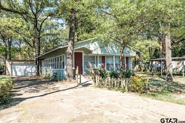 view of front facade featuring a garage and an outbuilding