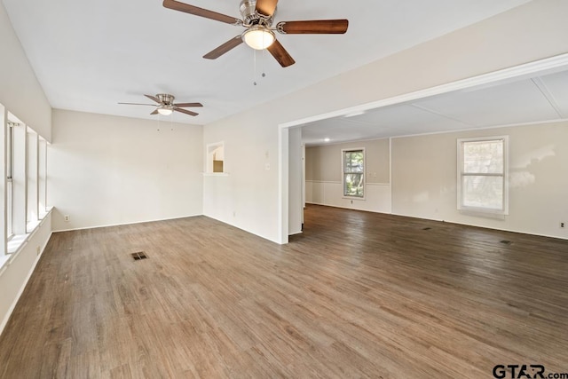 empty room with ceiling fan and wood-type flooring