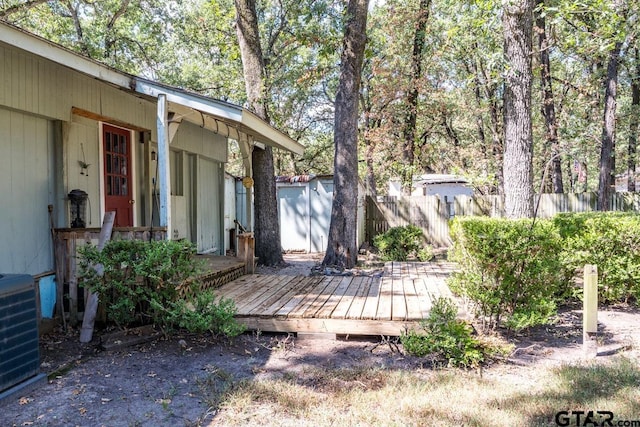 view of yard featuring a wooden deck and cooling unit