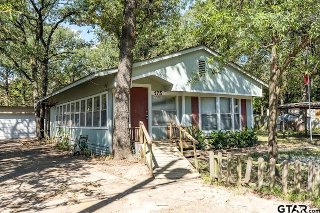 view of front facade with a garage and an outdoor structure