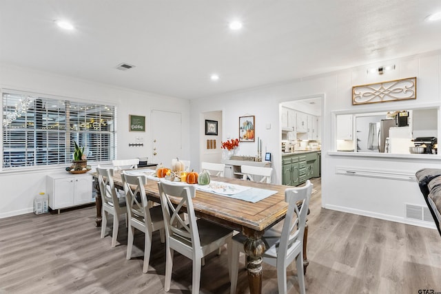 dining area featuring light wood-type flooring