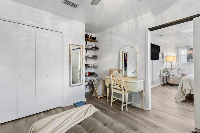 bedroom with ceiling fan, a closet, and light hardwood / wood-style flooring