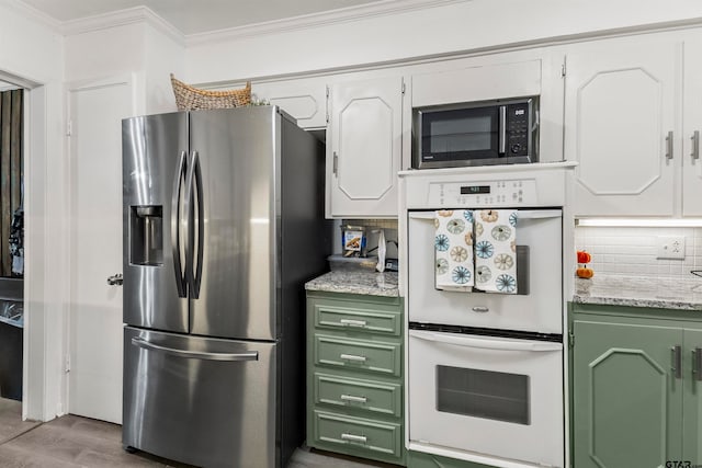 kitchen with light hardwood / wood-style floors, white cabinets, decorative backsplash, double oven, and stainless steel fridge