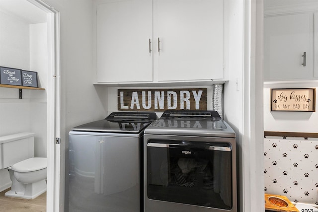 washroom with cabinets and independent washer and dryer