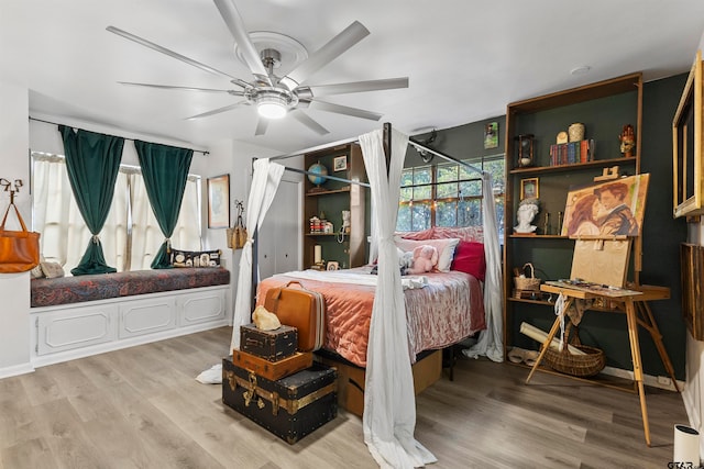 bedroom with light wood-type flooring and ceiling fan