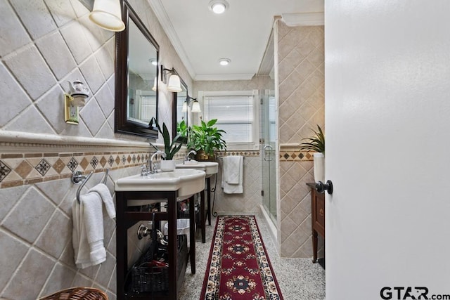 bathroom with crown molding, vanity, a stall shower, and tile walls