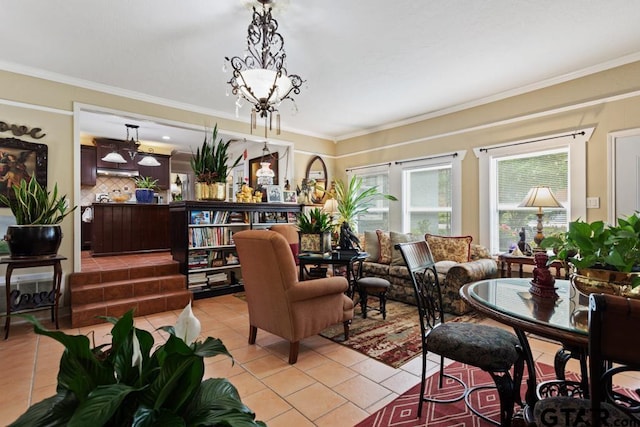 dining space with light tile patterned floors, crown molding, and an inviting chandelier