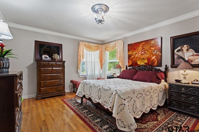 bedroom featuring crown molding, baseboards, and light wood finished floors
