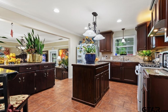 kitchen featuring dark brown cabinetry, stainless steel gas stove, a center island, decorative backsplash, and under cabinet range hood