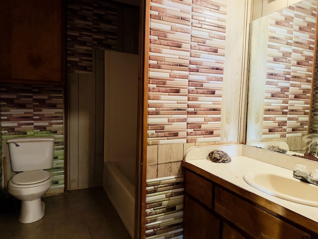 bathroom featuring tile patterned floors, vanity, toilet, and backsplash