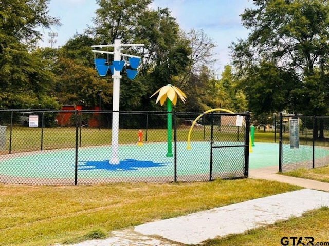 view of sport court featuring a yard