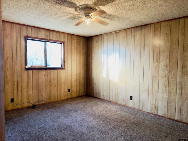 unfurnished room with carpet flooring and wood walls