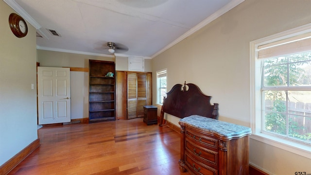 interior space with hardwood / wood-style floors, ceiling fan, and crown molding