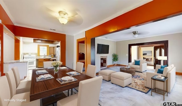 dining room featuring crown molding and ceiling fan