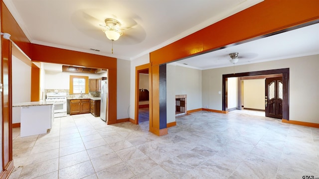 interior space with ceiling fan and ornamental molding