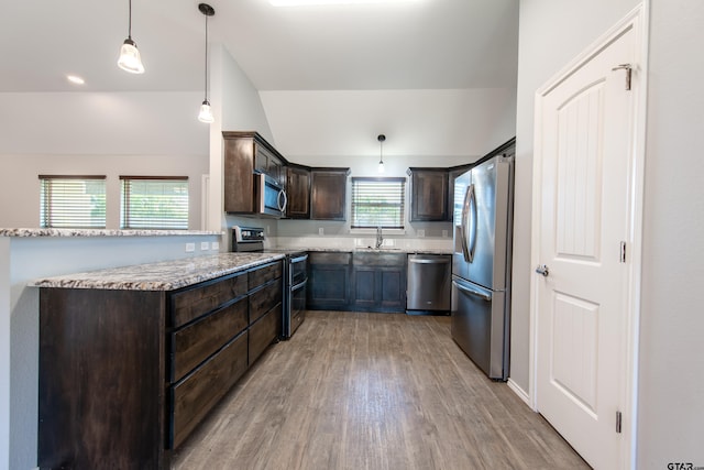 107 Oliver Wendell Ct, Mount Vernon, TX 75457 - kitchen with stainless steel appliances, a sink, dark brown cabinets, light wood-type flooring, and light stone countertops