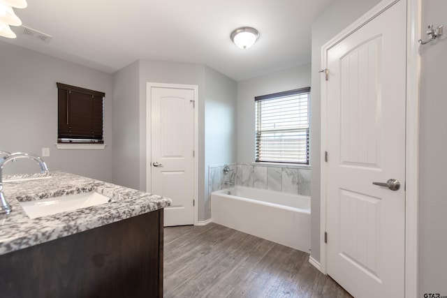 107 Oliver Wendell Ct, Mount Vernon, TX 75457 - full bath featuring wood finished floors, a bath, and double vanity