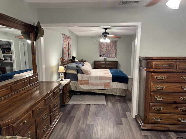 bedroom with ceiling fan and dark hardwood / wood-style flooring