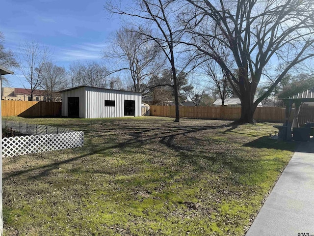 view of yard featuring a garage and an outdoor structure