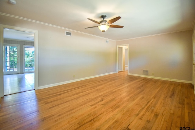 unfurnished room with crown molding, ceiling fan, and light hardwood / wood-style floors