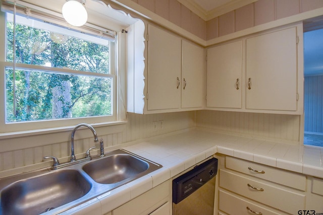 kitchen featuring dishwasher, sink, and tile counters