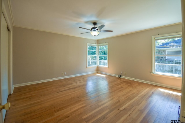 empty room featuring crown molding, ceiling fan, and light hardwood / wood-style flooring