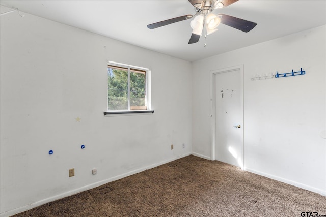 spare room featuring ceiling fan and carpet floors