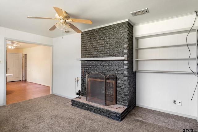 unfurnished living room with ornamental molding, a fireplace, built in features, and ceiling fan