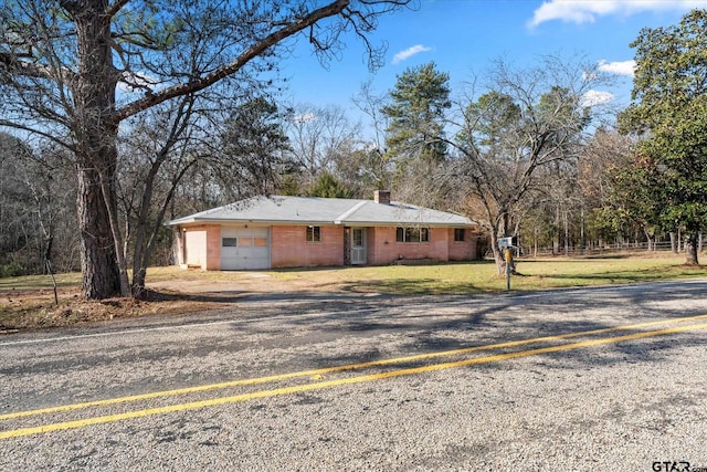 ranch-style home with a front lawn and a garage