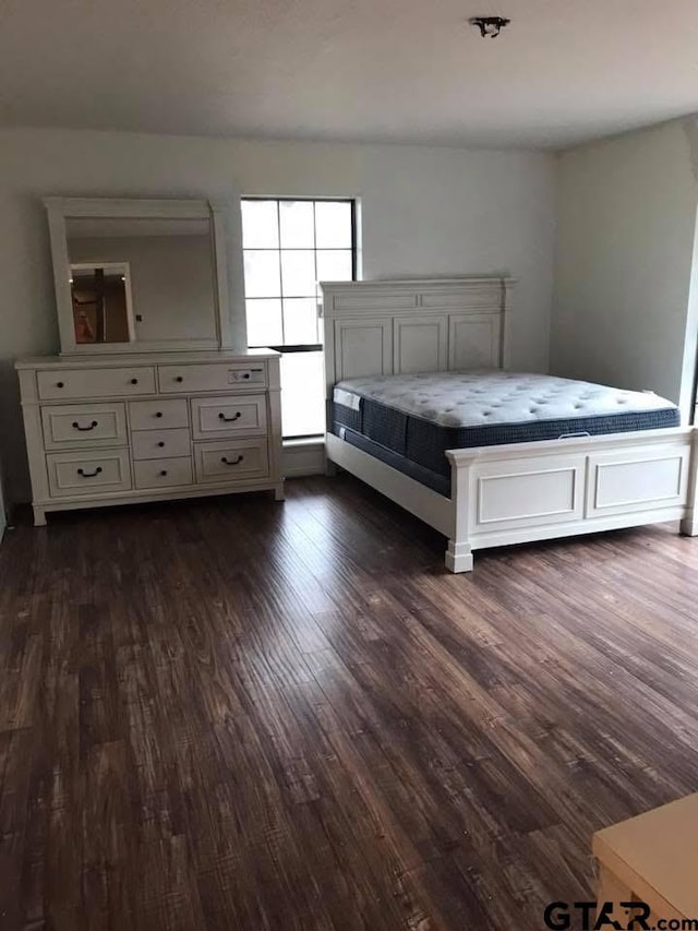 unfurnished bedroom featuring dark wood-type flooring